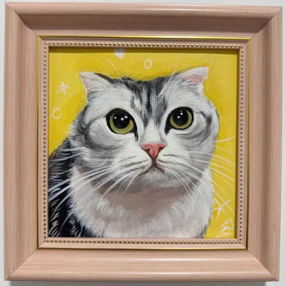 Framed custom hand-painted pet portrait of a rescue tabby cat displayed on a home wall, commissioned to celebrate a one-year gotcha day at Bolapawzi